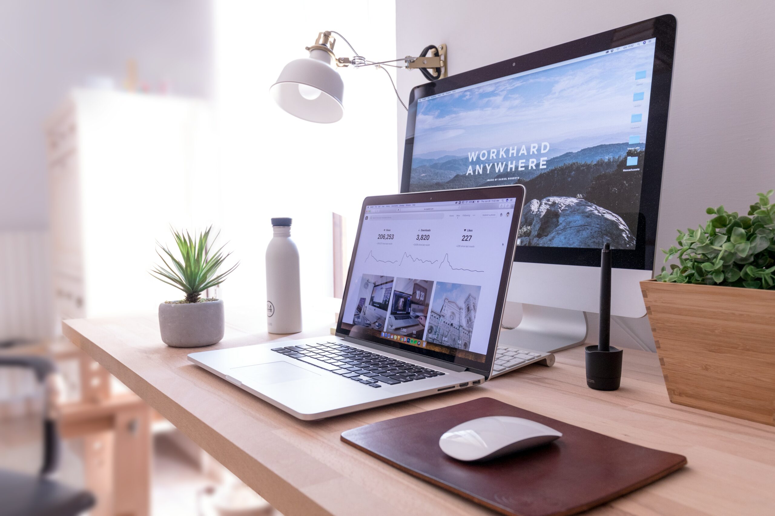 Photo of a laptop and desktop monitor on a desk